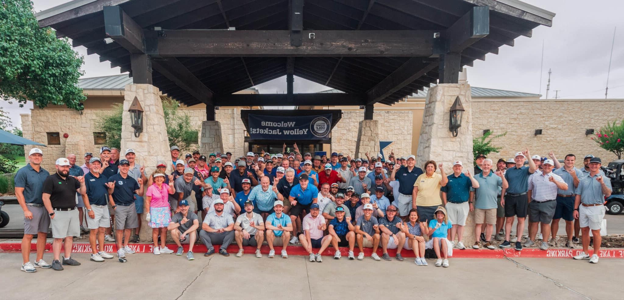 Attendees of HPU’s third annual North Texas 校友 Golf Tournament stand in front of Cowboys Golf Club in Grapevine.